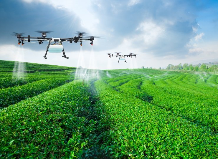 Agricultural drones over green crop field